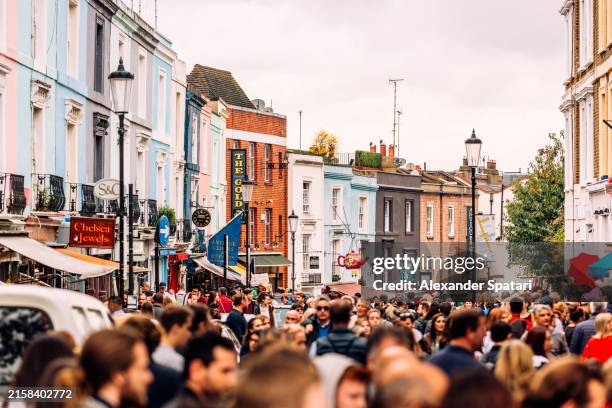 crowds of people shopping at portobello road market in notting hill, london, uk - kensington and chelsea stock pictures, royalty-free photos & images