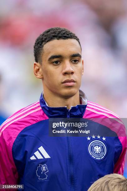 Jamal Musiala of Germany during his team's national anthem ahead of the UEFA EURO 2024 group stage match between Germany and Hungary at Stuttgart...