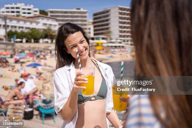 portrait of a young beautiful woman drinking white sangria on cala major beach in palma de mallorca - sangria stock pictures, royalty-free photos & images