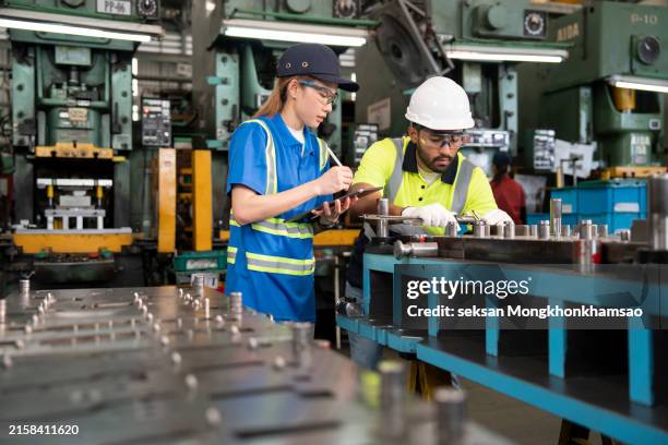 diversity of quality control engineers working in front of a press machine while routinely monitor the product design for issues. - mechanical engineering computer stock pictures, royalty-free photos & images