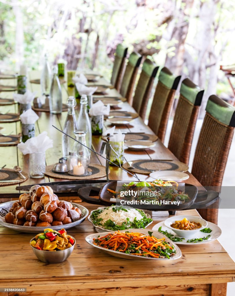 Beautifully presented colourful food displayed on a dining room table at a Luxury tented safari lodge, Botswana