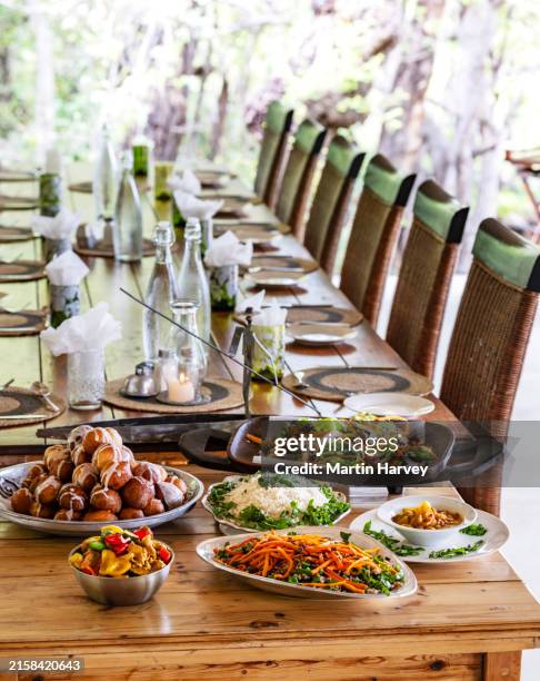 beautifully presented colourful food displayed on a dining room table at a luxury tented safari lodge, botswana - safari lodge stock pictures, royalty-free photos & images