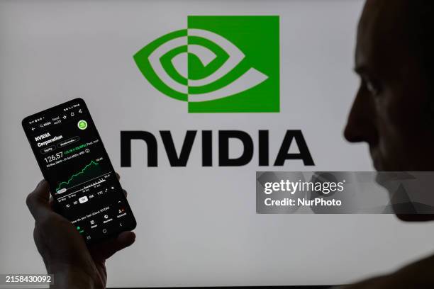 The NVIDIA stock market is being displayed on a smartphone, with NVIDIA visible in the background, in this photo illustration in Brussels, Belgium,...