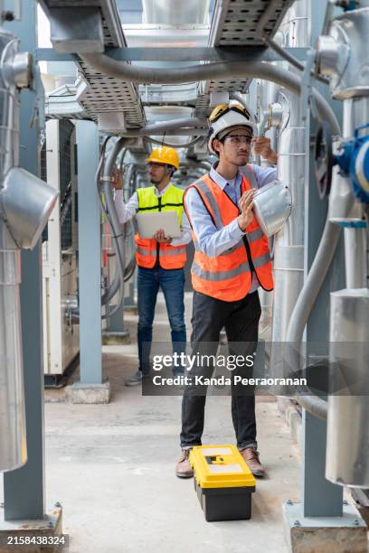 engineer under industrial inspection large water heaters are used in high-rise condominiums. - construction equipment stock pictures, royalty-free photos & images