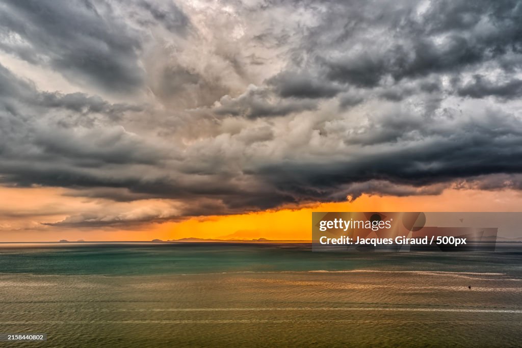Scenic view of sea against dramatic sky