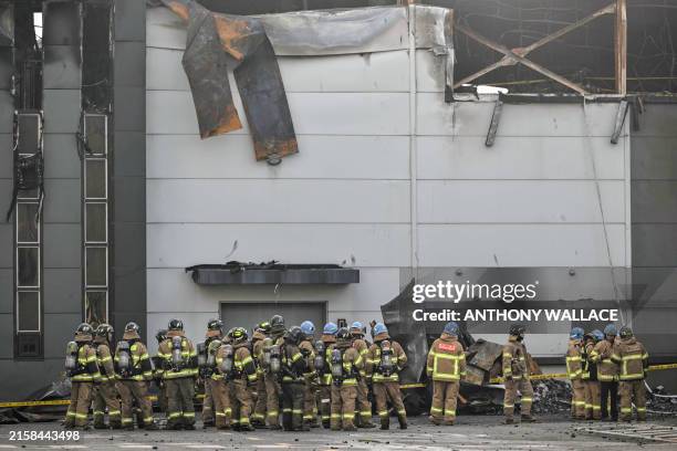 Firefighters gather at the site of a fire at a lithium battery factory owned by South Korean battery maker Aricell in Hwaseong on June 24, 2024....