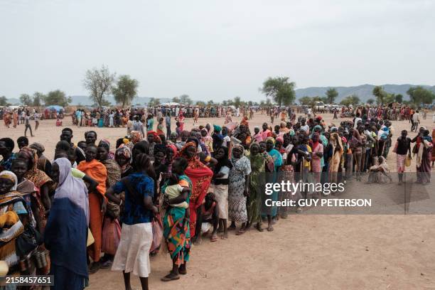People line up to register for a potential food aid delivery at a camp for internally displaced persons in Agari, South Kordofan, on June 17, 2024....