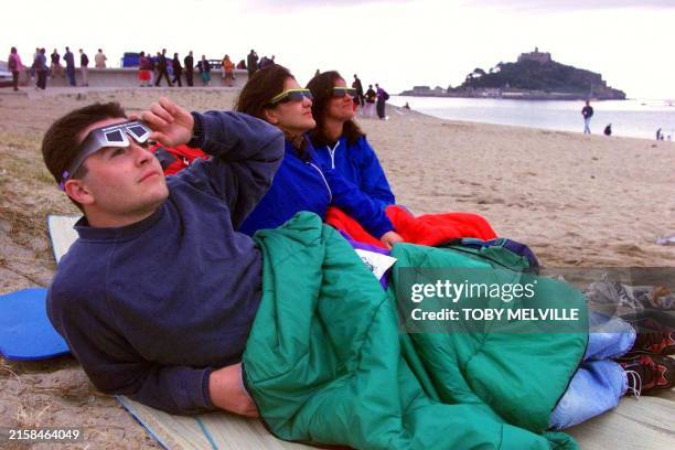 Three friends, , Gianluca Zani, Daniela Miglietta and Francesco Guarino, all from Italy, who travelled especially to England to view the eclipse,...