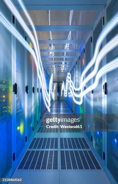illuminated network waves in data server room at center - supercomputer stock illustrations
