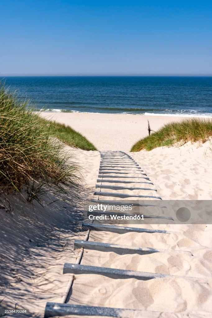 Germany, Schleswig-Holstein, Boardwalk on sandy beach of Sylt island