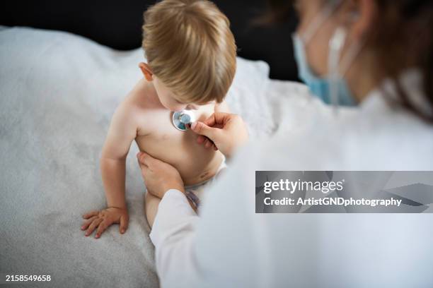 doctor examining little patient at home visitation. - cold virus stock pictures, royalty-free photos & images