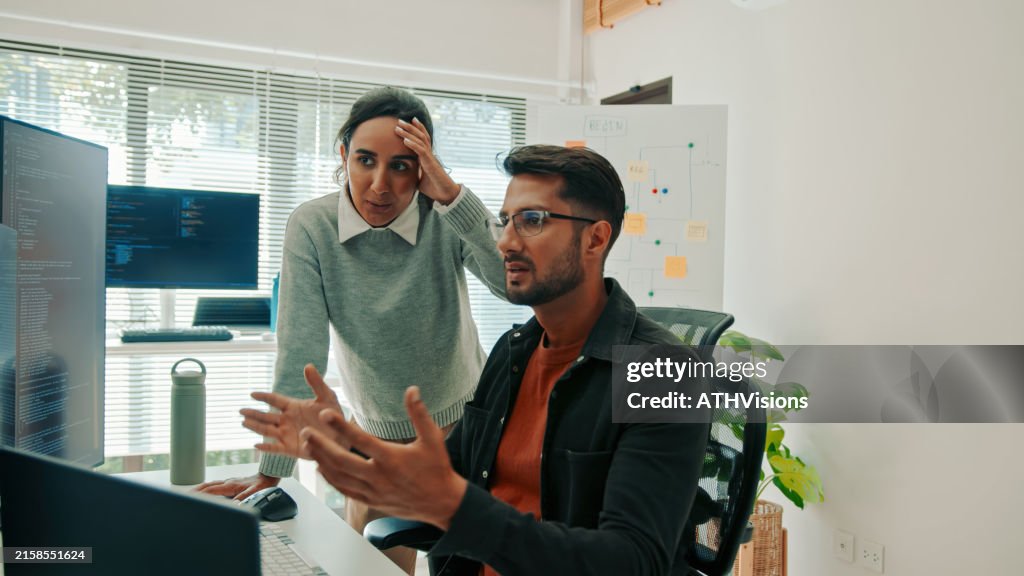 Hispanic Software Developers Discussing Code Solutions