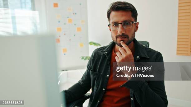 focused hispanic programmer debugging code - software programmer stock pictures, royalty-free photos & images