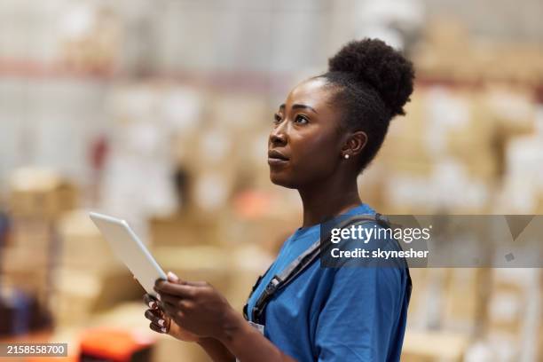 black female worker using touchpad in supply chain. - touchpad stock pictures, royalty-free photos & images