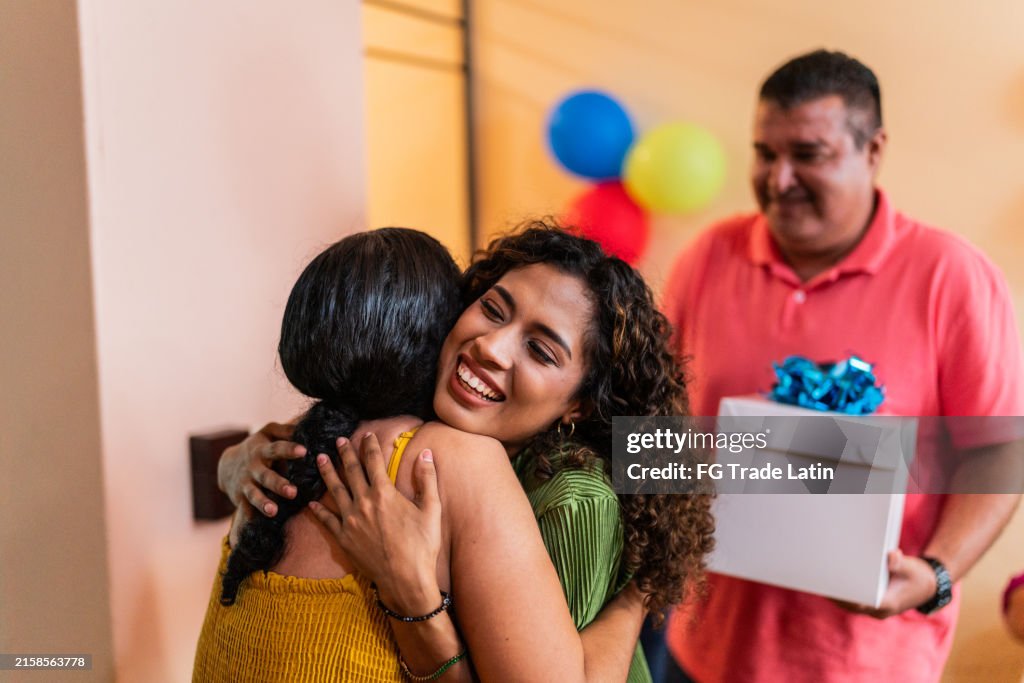 Young woman greeting aunt at home