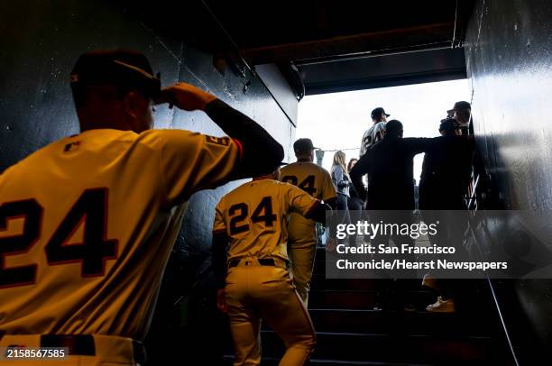 Giants players wearing "24" in honor of Willie Mays leave the clubhouse for the field before the San Francisco Giants played the Chicago Cubs at...