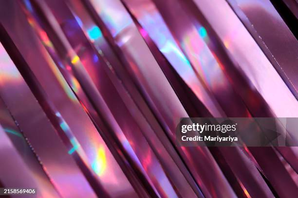 tinsel with a holographic effect. festive abstract background with shining bokeh in lilac shades. perfect for birthdays and christmas. - magenta stock pictures, royalty-free photos & images