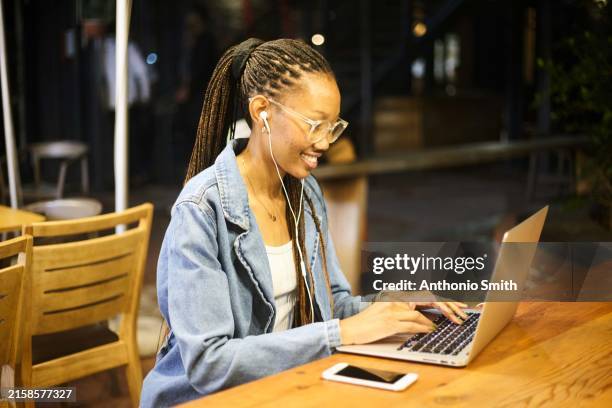urban productivity: coffee shop laptop vibes - digital nomad stock pictures, royalty-free photos & images