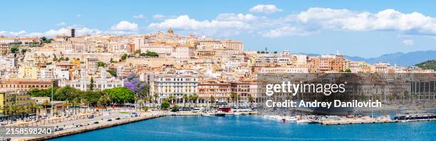 panoramic view of cagliari skyline and marina with boats in sardinia. - cagliari stock pictures, royalty-free photos & images