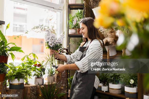 florist creating a bouquet - flower shop stock pictures, royalty-free photos & images