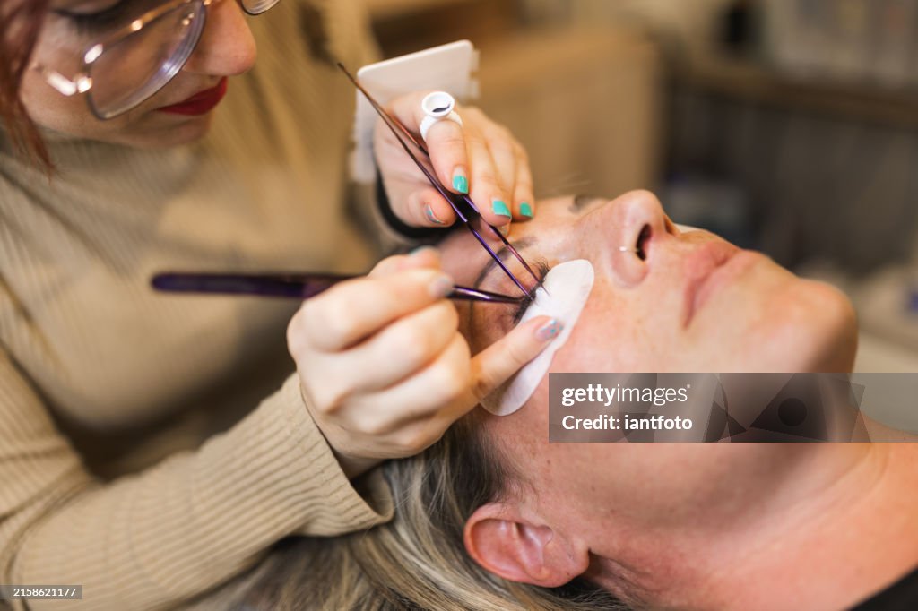 Elegance in false eyelash application by a professional makeup artist.