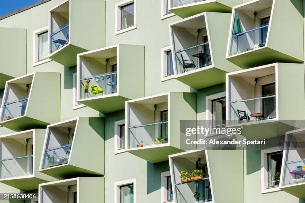 block shaped apartment balconies of a modern residential building, copenhagen, denmark - modern house denmark stock pictures, royalty-free photos & images