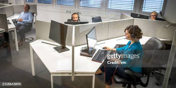 diverse office staff in modern cubicle workspace - arab call center stock pictures, royalty-free photos & images
