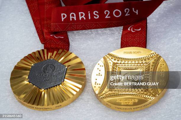 This photograph shows Men's Paralympic gold medals for wheelchair basketball displayed in the workshops of La Monnaie de Paris, in Paris on June 25...