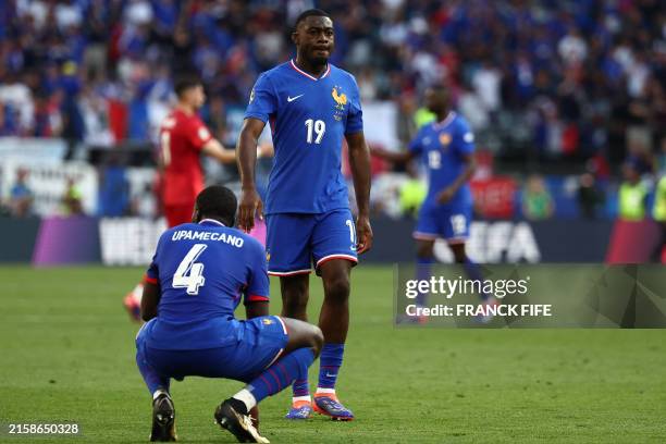 France's defender Dayot Upamecano and France's midfielder Youssouf Fofana react after the UEFA Euro 2024 Group D football match between France and...