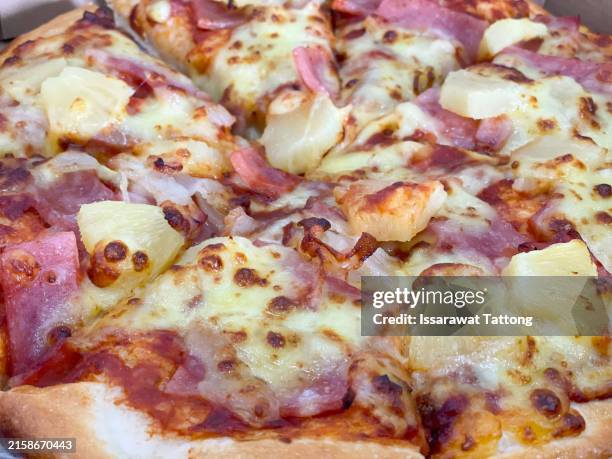 a pizza with ham and pineapple toppings - hawaiian pizza stock pictures, royalty-free photos & images