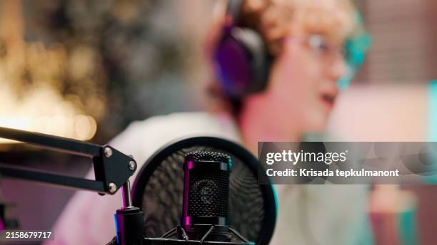 young asian man recording podcast from home studio. - locutor-de-rádio imagens e fotografias de stock