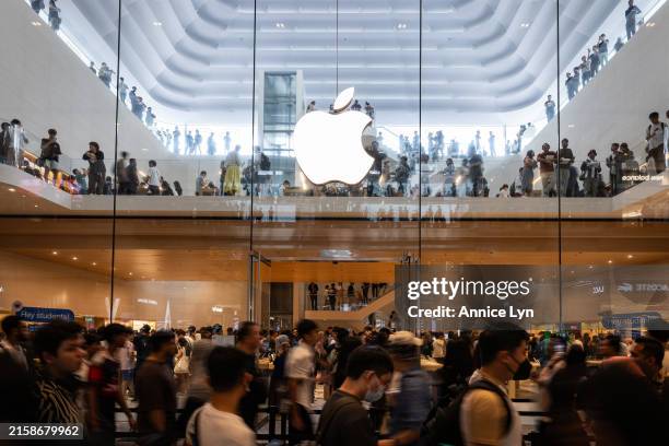 People line up as they make their way into the new Apple store at the Tun Razak Exchange on June 22 in Kuala Lumpur, Malaysia. Apple’s first retail...