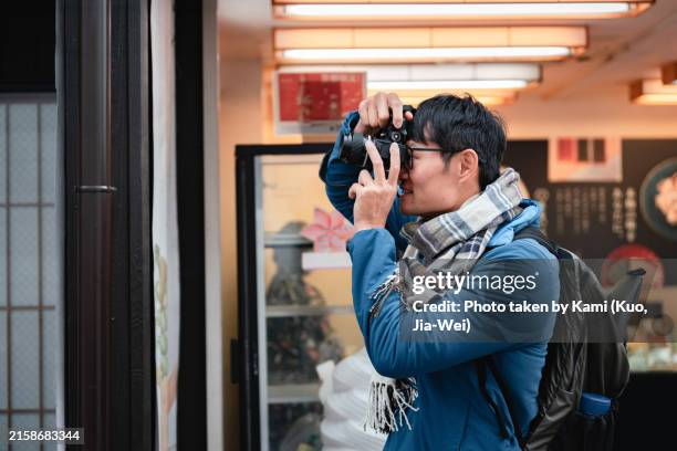 photographer capturing urban scene - japanese man with camera stock pictures, royalty-free photos & images