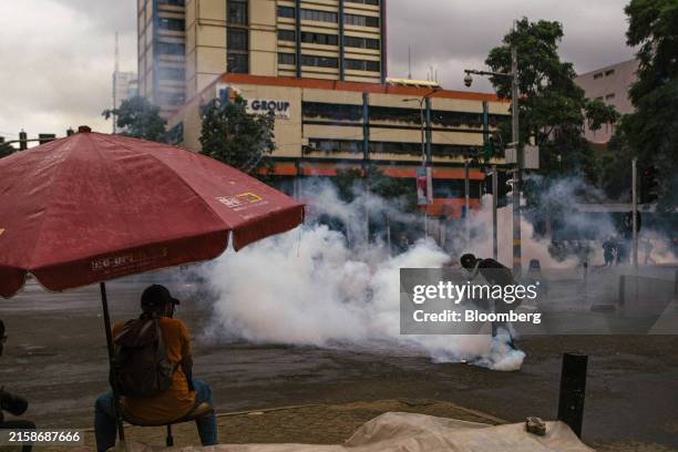 Police use tear gas to disperse protesters against the proposed government tax bill in the Central Business District of Nairobi, Kenya, on Tuesday,...