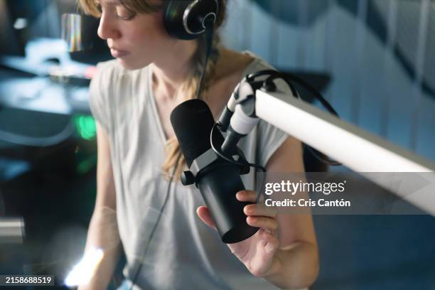 female radio host working in broadcasting studio - radio host stock pictures, royalty-free photos & images