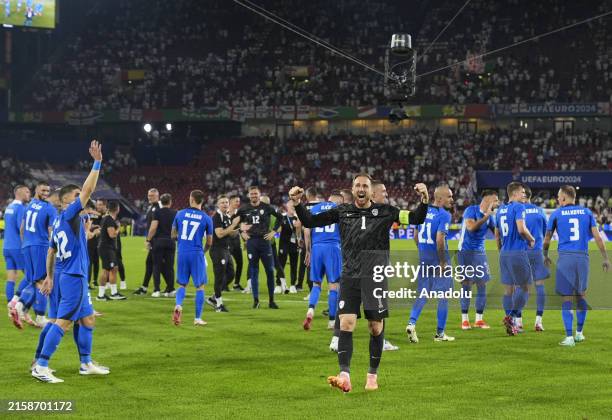 Slovenia's players celebrate qualifying for the knock-out stages on the pitch after the UEFA EURO 2024 Group C match between England and Slovenia at...