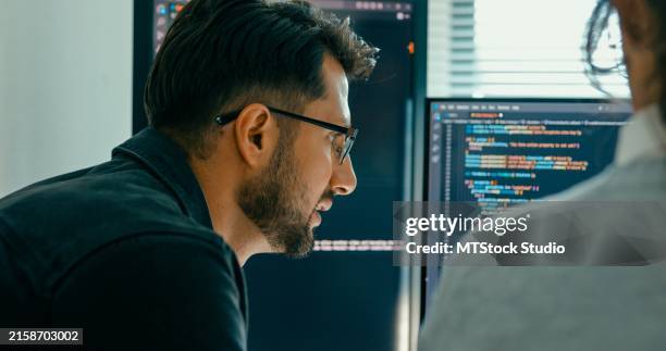 closeup of software engineering team engaged in problem-solving and code analysis for web development in modern office. software developer, artificial intelligence and programming. - application programming interface stockfoto's en -beelden