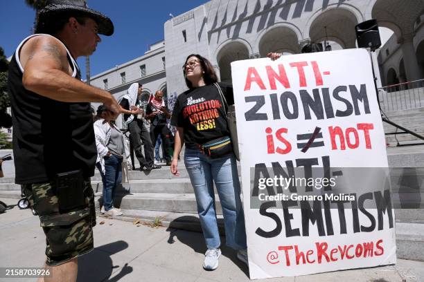 Sunsara Taylor, stands next to her sign while joining members of the Palestinian Youth Movement, Stop LAPD Spying, Party for Socialism and...