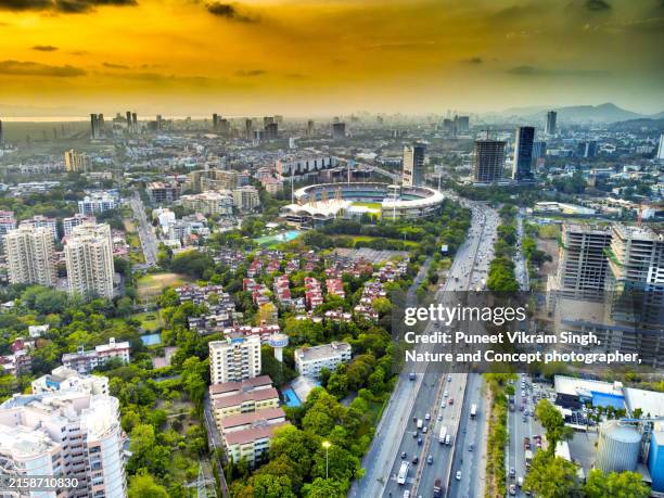 cityscape and skyline of navi mumbai during a moody sunset as viewed from a drone's perspective. shot taken at nerul, navi mumbai. - india transport stock pictures, royalty-free photos & images