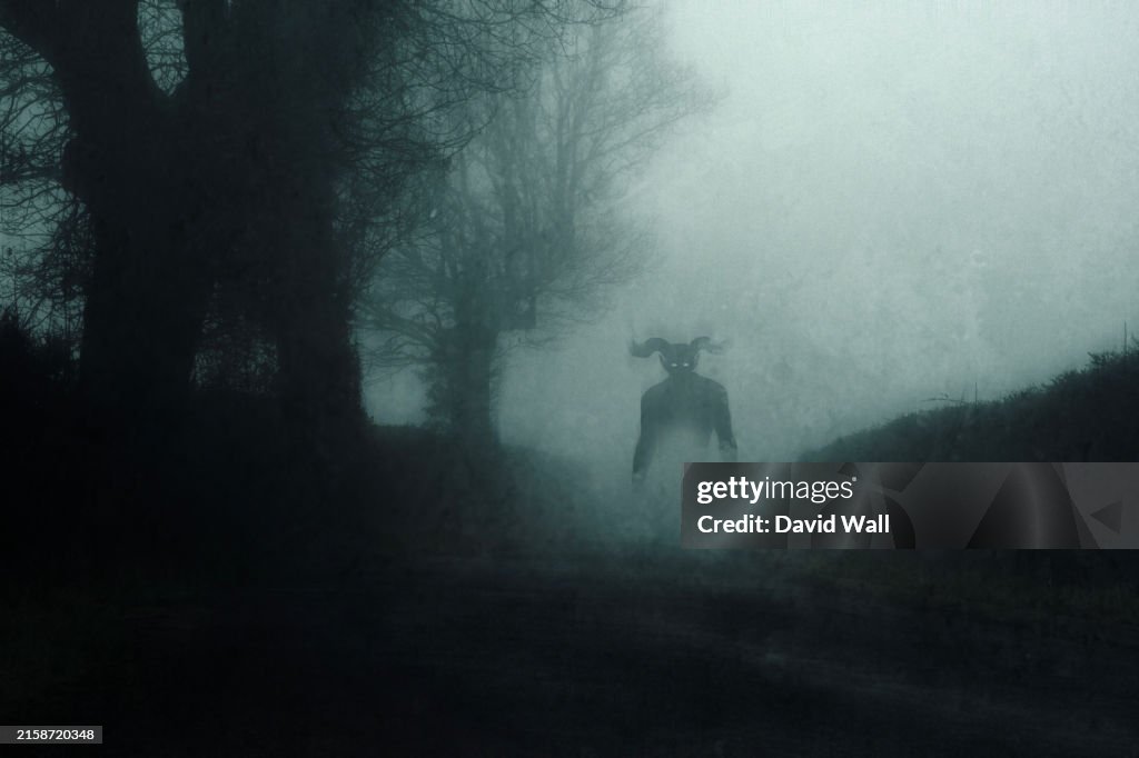 A supernatural demon. standing on a road. On a spooky foggy night in the countryside. With a grunge abstract edit.