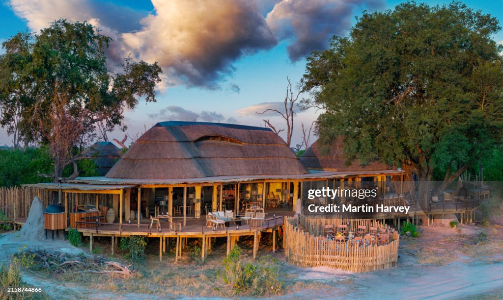 Aerial view of the entertainment, reception and dining area with fire pit at an exclusive luxury tented safari lodge, Botswana