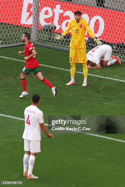 Altay Bayindir of Turkiye reacts towards teammate Samet Akaydin after Samet Akaydin scores an own goal and Portugal's second goal during the UEFA...