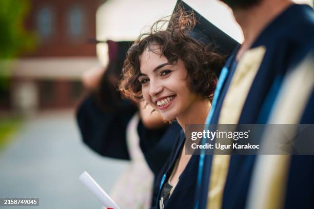 graduating young woman in line at the ceremony. - graduation portrait woman stock pictures, royalty-free photos & images