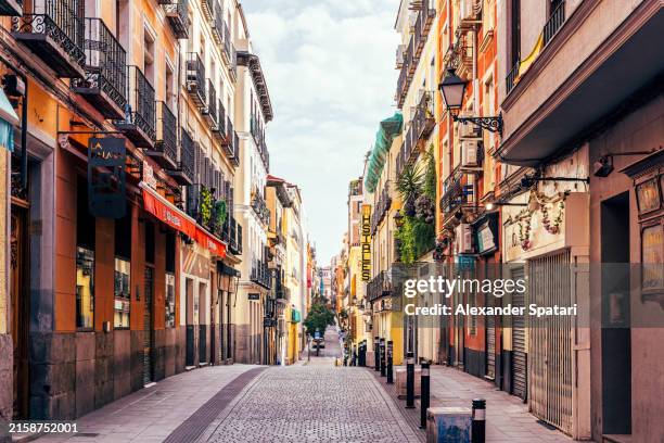 street in malasaña neighbourhood with shops and cafes, madrid, spain - madrid stockfoto's en -beelden