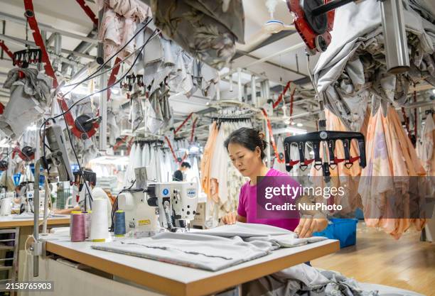 Worker is working in an orderly production line at a smart workshop of a home textile company in Nantong, China, on June 25, 2024.
