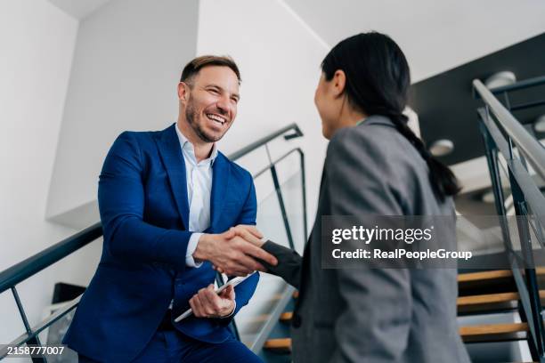 professionals shaking hands with a smile. - reliability stock pictures, royalty-free photos & images
