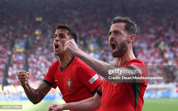 Bernardo Silva of Portugal celebrates scoring his team's first goal with teammate Joao Cancelo during the UEFA EURO 2024 group stage match between...
