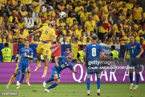 Romania's forward Denis Dragus fights for the ball with Slovakia's midfielder Stanislav Lobotka during the UEFA Euro 2024 Group E football match...