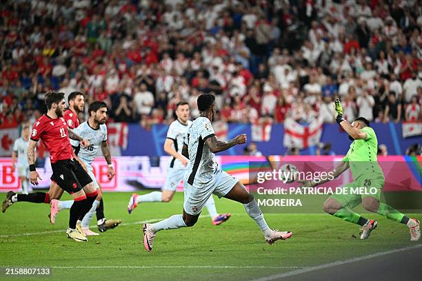 Georgia's goalkeeper Giorgi Mamardashvili makes a save during the UEFA Euro 2024 Group F football match between Georgia and Portugal at the Arena...
