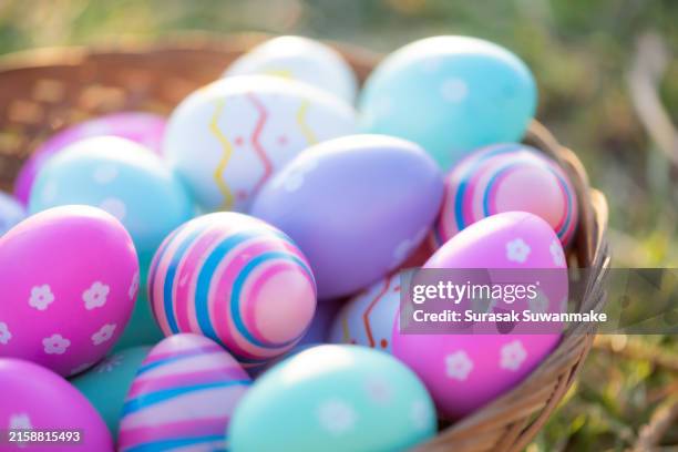 colorful easter eggs festive background in green grass with painted eggs and little butterflies flying on a sunny sunday in spring (easter holiday celebration background concept) - flying egg stock pictures, royalty-free photos & images